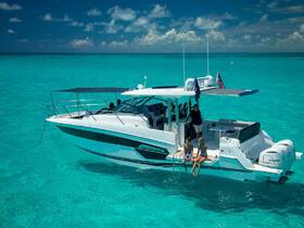 A group enjoys a sunny day on a sleek boat, relaxing by the turquoise waters — perfect for summer adventures and family outings.