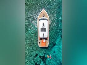 An aerial view of a boat anchored in crystal-clear waters, with a person swimming nearby, showcasing the perfect summer getaway on the water.