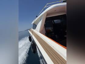 A sleek speedboat glides through calm waters, showcasing its elegant design and smooth lines — perfect for thrilling adventures on the open sea.