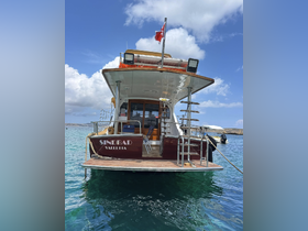 A striking view of the 'Sindbad' yacht docked in clear waters, showcasing its elegant design and inviting atmosphere.