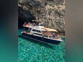 A lively group enjoys a day on a boat surrounded by stunning clear waters and rocky cliffs, perfect for exploring hidden caves and enjoying the sun.