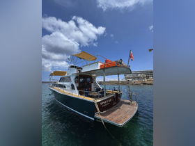 A beautifully docked yacht named 'Sinbad' in clear waters, showcasing its elegant design and inviting atmosphere.
