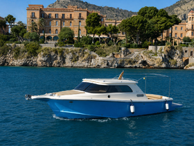 A stunning yacht glides through clear waters, showcasing its elegant design against a picturesque coastal backdrop.