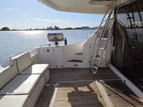A spacious interior view of a boat featuring comfortable seating and a helm area, perfect for relaxing or navigating on the water.