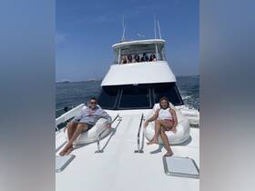 A group of friends relaxes on the deck of a boat, enjoying a sunny day on the water — perfect for social gatherings and leisure outings.