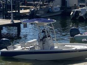 A sleek speedboat docked at the marina, showcasing its clean lines and inviting seating, perfect for a day on the water.
