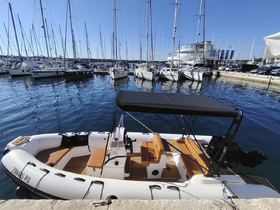 A sleek speedboat docked at a marina, showcasing its stylish design and spacious seating — perfect for day trips on the water.