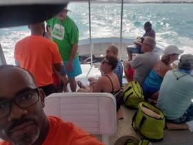 A lively group enjoys their time aboard a boat, engaging in conversation and relaxation while cruising on the water.