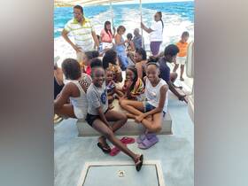 A lively group of friends and family enjoys their time aboard a boat, capturing the essence of fun and togetherness on the water.