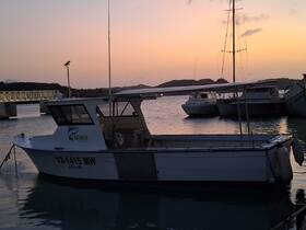 A fishing boat docked at sunset, showcasing its sleek design against a tranquil harbor backdrop — perfect for fishing excursions or leisurely cruises.