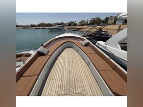 A beautifully designed lounge area on a boat, featuring comfortable seating and a polished wooden deck, perfect for relaxing while enjoying the water.