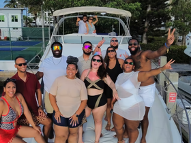 A lively group celebrates aboard a boat, showcasing joy and camaraderie — perfect for unforgettable gatherings on the water.