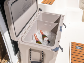 A well-stocked cooler filled with ice and champagne bottles, perfect for keeping drinks chilled during a day on the water.