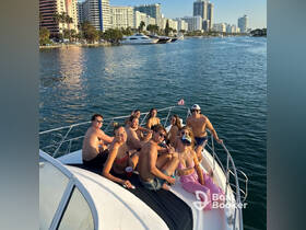 A lively group enjoys a sunny day on a yacht, capturing the essence of fun and celebration on the water with friends.