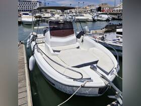 A sleek speedboat docked at the marina, showcasing its modern design and spacious seating area, perfect for day trips on the water.