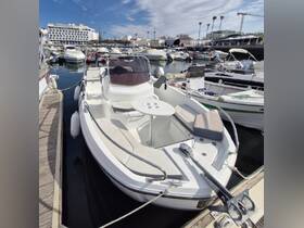 A sleek speedboat docked at the marina, showcasing its modern design and comfortable seating, perfect for day trips on the water.