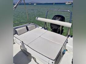 A cozy seating area on a boat, featuring comfortable cushions, perfect for relaxing while enjoying the scenic views on the water.