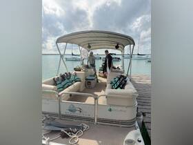 Inside view of a pontoon boat featuring comfortable seating and safety gear, with guests preparing for an exciting day on the water.