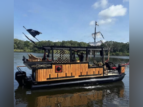 A beautifully crafted tiki boat with a pirate theme, showcasing its unique design as it floats on calm waters, perfect for themed parties or leisurely cruises.