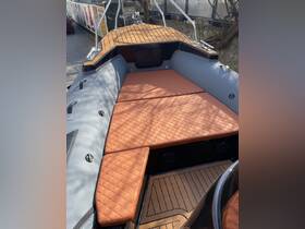 Interior view of a stylish boat seating area featuring plush cushions and a sleek design, perfect for relaxation on the water.