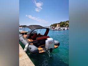 A sleek speedboat docked in clear turquoise waters, showcasing its modern design and powerful outboard motor — perfect for thrilling water adventures.