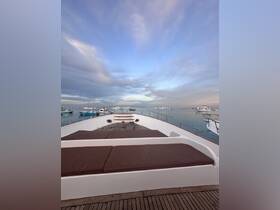 A serene view from the front deck of a yacht, showcasing the spacious seating area and tranquil waters, perfect for relaxing on a day out at sea.