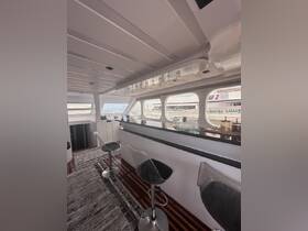 A stylish interior view of a boat's cabin featuring modern seating and a bar area, perfect for relaxing and entertaining while on the water.