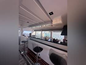 A stylish interior view of a boat's cabin featuring a sleek bar area and modern seating, perfect for entertaining guests while enjoying the scenic views outside.