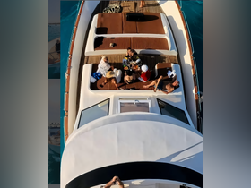 A lively group enjoys a meal on the deck of a yacht, perfect for celebrations and social gatherings on the water.
