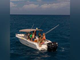 A lively group enjoys a day out on the ocean aboard the 'Ti Tom' boat, showcasing the perfect atmosphere for fun and adventure on the water.