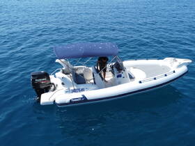 A sleek speedboat glides through clear blue waters, showcasing its modern design and powerful Suzuki engine — perfect for thrilling adventures on the sea.