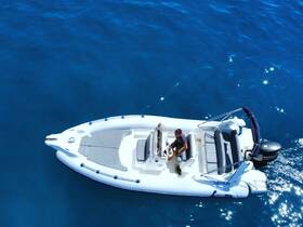 Aerial view of a sleek speedboat with a person at the helm, navigating through vibrant blue waters — perfect for thrilling adventures on the open sea.