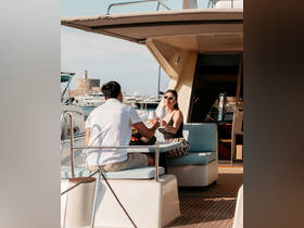 A couple enjoys cocktails and a delightful meal on the deck of a yacht, perfect for romantic getaways or special celebrations on the water.