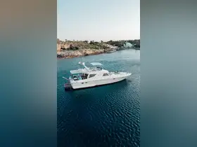 Aerial view of a luxurious yacht docked in serene waters, showcasing its elegant design and perfect for upscale boating experiences.