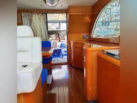 Interior view of a luxurious boat cabin featuring elegant wooden finishes and comfortable seating, perfect for relaxing while on the water.