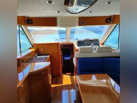 A beautifully designed interior of a boat's helm and cabin area, showcasing modern amenities and a spacious layout, perfect for comfortable cruising.