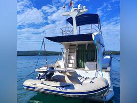 A clear view of a yacht docked in calm waters, showcasing its structure and design against a picturesque sky.