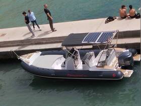 A sleek speedboat docked at the marina, showcasing its modern design and solar panel features, with people casually enjoying the waterfront.