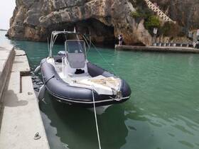 A sleek speedboat docked in a serene harbor, surrounded by rocky cliffs — perfect for exploring coastal waters.