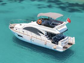 A stunning aerial view of a luxurious yacht anchored in crystal-clear turquoise waters, perfect for summer getaways and private charters.