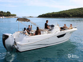 A lively group enjoys a private boat tour, relaxing on the deck while cruising through serene waters — perfect for a day of fun and exploration.
