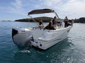 A lively group enjoys a day out on the water aboard a sleek boat, showcasing the perfect setting for fun and relaxation.