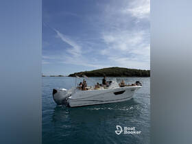 A lively group enjoys a day on the water aboard a sleek boat, perfect for creating unforgettable memories with friends.