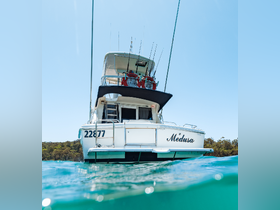 A striking view of the 'Medusa' yacht from the water, showcasing its sleek design and fishing gear — perfect for a day out on the ocean.