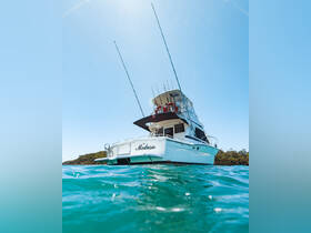 A stunning view of the fishing boat 'Medusa' gliding through clear waters, showcasing its sleek design and fishing gear — perfect for anglers seeking adventure on the open sea.