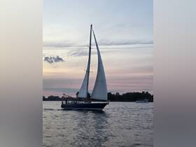A beautiful sailboat glides through the water at sunset, showcasing its elegant sails against a colorful sky — perfect for evening cruises.