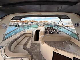 Interior view of a luxurious boat helm and seating area, showcasing modern amenities and a spacious layout, perfect for comfortable cruising.