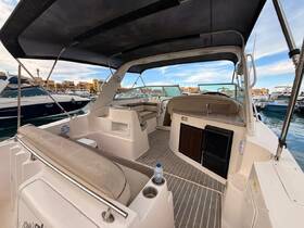 Interior view of a spacious boat cabin featuring comfortable seating and a helm area, perfect for relaxing and enjoying time on the water.