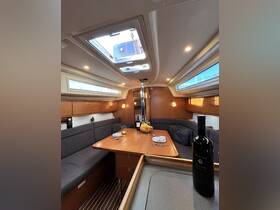 A cozy interior view of a sailboat's cabin featuring a dining area with elegant seating, perfect for enjoying meals and relaxation while on the water.