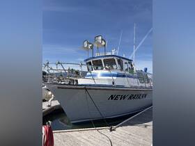 A clear view of the 'NEW RAYANN' boat docked at the marina, showcasing its structure and design against a bright blue sky.